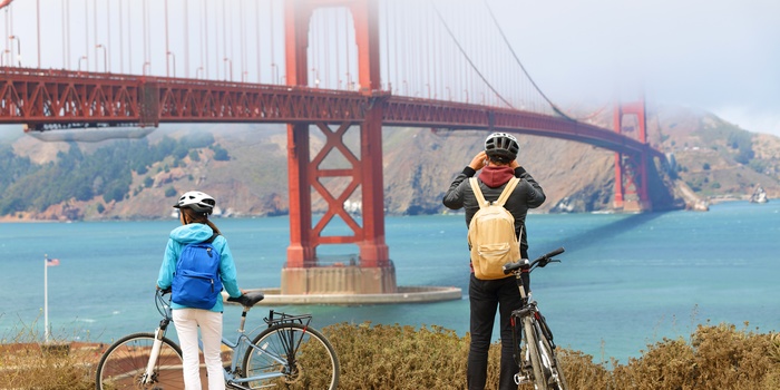 Par på cykel fotograferer Golden Gate, San Francisco i USA