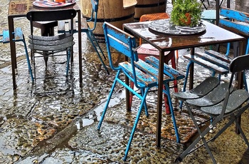 Cafestole ved kanalen i Navigli-kvarteret i Milano