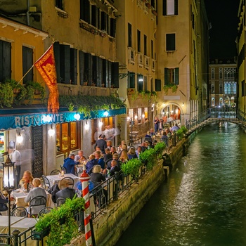 Restauranter langs en kanal i Venedig