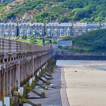 Wales, Barmouth - jernbane og fodgængerbro over Afon Mawddach og byhuse i baggrunden