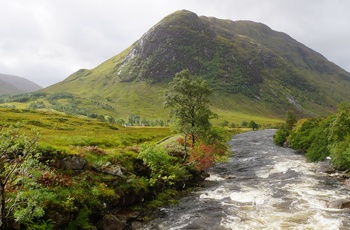 Floden River Coe skærer sig igennem det grønne landskab i Glencoe, Skotland