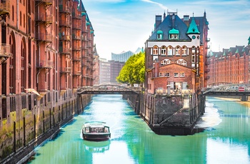 Kanal med turbåd i Speicherstadt distriktet i Hamborg