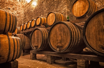 Trætønder med vin i en gammel vinkælder, Italien